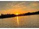 Picturesque lake view featuring a radiant sunset, reflecting warm golden light on the water at 5801 Marleon Drive Marleon Drive, Windermere, FL 34786