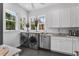 Well-lit laundry room with stainless steel appliances, granite countertops, and ample storage at 5801 Marleon Drive Marleon Drive, Windermere, FL 34786