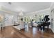 Bright living room with a piano, chandelier, and hardwood flooring at 5801 Marleon Drive Marleon Drive, Windermere, FL 34786