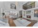 Expansive living room featuring a fireplace, hardwood floors, and second-story balcony views at 5801 Marleon Drive Marleon Drive, Windermere, FL 34786