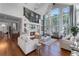 Bright living room with high ceilings, large windows, fireplace, and modern decor at 5801 Marleon Drive Marleon Drive, Windermere, FL 34786