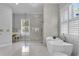 Beautiful main bathroom featuring a glass shower, soaker tub, and vanity area at 5801 Marleon Drive Marleon Drive, Windermere, FL 34786