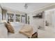 Comfortable main bedroom featuring large windows with backyard views, a television and neutral tones at 5801 Marleon Drive Marleon Drive, Windermere, FL 34786