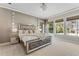 Luxurious main bedroom with stylish decor, plush bedding, and scenic backyard views at 5801 Marleon Drive Marleon Drive, Windermere, FL 34786