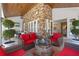 Covered outdoor living area with a stone wall, TV, gas fireplace, and comfortable seating at 5801 Marleon Drive Marleon Drive, Windermere, FL 34786