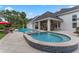 An inground pool with a water feature, a spa, and a covered outdoor living space are highlights of this backyard at 5801 Marleon Drive Marleon Drive, Windermere, FL 34786