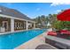 Spacious in-ground pool with stone border, spa, fountains, an outdoor dining area, and a covered outdoor seating area at 5801 Marleon Drive Marleon Drive, Windermere, FL 34786