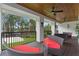 Covered porch featuring comfortable seating, ceiling fans, and scenic views of the lush surroundings at 5801 Marleon Drive Marleon Drive, Windermere, FL 34786