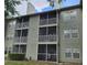 Exterior view of multi-story condo building with multiple screened-in patios or balconies at 5980 Westgate Dr Dr # 202, Orlando, FL 32835