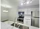 A modern kitchen with white cabinets, stainless steel appliances, and ample counter space at 5980 Westgate Dr Dr # 202, Orlando, FL 32835