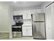 Well-equipped kitchen features stainless steel appliances and bright white cabinets at 5980 Westgate Dr Dr # 202, Orlando, FL 32835