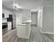 Kitchen with stainless steel appliances, white cabinets, and breakfast bar at 5980 Westgate Dr Dr # 202, Orlando, FL 32835
