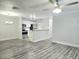 Spacious living area features updated gray floors and a ceiling fan at 5980 Westgate Dr Dr # 202, Orlando, FL 32835