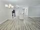 An open floor plan with modern lighting, gray wood-look floors, and neutral paint at 5980 Westgate Dr Dr # 202, Orlando, FL 32835
