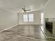 Bright living room featuring gray flooring, natural light, and fireplace at 5980 Westgate Dr Dr # 202, Orlando, FL 32835