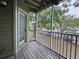 View from screened-in porch featuring a wooden floor, railings, and view of surrounding landscape at 5980 Westgate Dr Dr # 202, Orlando, FL 32835