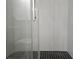 Modern bathroom with glass shower door and grey and black patterned tile flooring at 5980 Westgate Dr Dr # 202, Orlando, FL 32835