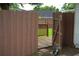 Wooden gate opens to backyard with wooden deck, offering a charming and private outdoor retreat at 6500 Abercrombie Ct, Orlando, FL 32835