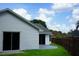 Sliding glass doors to back patio, fenced in backyard, and white siding at 6500 Abercrombie Ct, Orlando, FL 32835