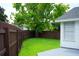 Landscaped backyard with privacy fence and manicured lawn offers a serene outdoor living space at 6500 Abercrombie Ct, Orlando, FL 32835