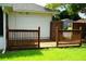 A wooden deck adds charm to this yard with green grass, surrounded by a wooden fence, offering a tranquil outdoor space at 6500 Abercrombie Ct, Orlando, FL 32835