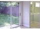 View of backyard with sliding glass door and partial bathroom view with shower at 6500 Abercrombie Ct, Orlando, FL 32835