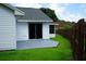 Sliding glass doors to back patio, fenced in backyard, and white siding at 6500 Abercrombie Ct, Orlando, FL 32835