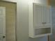 Bright bathroom featuring a white cabinet with shelves and a tiled shower area at 6500 Abercrombie Ct, Orlando, FL 32835