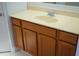 Bathroom vanity with cabinet, sink, chrome faucet, and framed mirror at 6500 Abercrombie Ct, Orlando, FL 32835