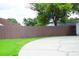 Long concrete driveway and tall wooden fence in the front of the home at 6500 Abercrombie Ct, Orlando, FL 32835