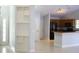 Open living space with tile floors, built-in shelving, and a view of the kitchen area at 6500 Abercrombie Ct, Orlando, FL 32835