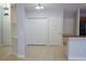 Neutral living space with tile flooring, closet doors, and opening to kitchen at 6500 Abercrombie Ct, Orlando, FL 32835