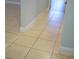 Tile flooring with white baseboards in the hallway, showcasing its clean, modern design at 6500 Abercrombie Ct, Orlando, FL 32835