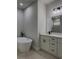 Modern bathroom featuring a soaking tub, double vanity with stylish fixtures and neutral tile flooring at 6516 Sw 149 Th Lane Rd, Ocala, FL 34473