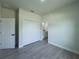 Bedroom with closet and bathroom access features neutral walls and wood-look flooring at 6516 Sw 149 Th Lane Rd, Ocala, FL 34473