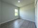 Bright bedroom with closet, light gray walls, and wood-look flooring at 6516 Sw 149 Th Lane Rd, Ocala, FL 34473