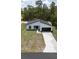 New construction home with dark accents, a two-car garage, and a long driveway at 6516 Sw 149 Th Lane Rd, Ocala, FL 34473