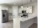 Modern kitchen featuring a breakfast bar, stainless steel appliances, and pendant lighting at 6516 Sw 149 Th Lane Rd, Ocala, FL 34473