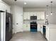 Kitchen with stainless steel appliances, white cabinets, and a stylish faucet at 6516 Sw 149 Th Lane Rd, Ocala, FL 34473