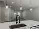 Close up of kitchen breakfast bar with a modern faucet and pendant lighting at 6516 Sw 149 Th Lane Rd, Ocala, FL 34473