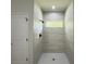 Modern shower with tiled walls and floor, and a window at 6516 Sw 149 Th Lane Rd, Ocala, FL 34473