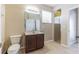 Bathroom features a vanity with storage, tile floors, and glass enclosed shower at 7184 Maleberry Run, Winter Garden, FL 34787