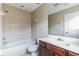 Cozy bathroom featuring a shower-tub combo, a toilet, and a sink with a dark wood cabinet at 7184 Maleberry Run, Winter Garden, FL 34787