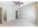 Spacious bedroom features a ceiling fan, neutral tones, and closet for comfortable living at 7184 Maleberry Run, Winter Garden, FL 34787