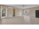 Spacious bedroom features neutral tones, tiled floors, and balcony access to allow for comfortable living at 7184 Maleberry Run, Winter Garden, FL 34787