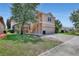 Charming two-story home with a manicured lawn, brick driveway, and access via outdoor stairs at 7184 Maleberry Run, Winter Garden, FL 34787