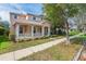 Charming two-story home with a welcoming front porch and manicured landscaping at 7184 Maleberry Run, Winter Garden, FL 34787