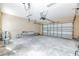 Spacious two car garage with concrete flooring and lots of room for parking and storage at 7184 Maleberry Run, Winter Garden, FL 34787