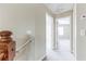 Upstairs hallway with neutral paint and carpet leading to bedrooms with natural lighting at 7184 Maleberry Run, Winter Garden, FL 34787