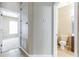 Hallway with tile floors leading to bathroom and bedroom with natural lighting and neutral walls at 7184 Maleberry Run, Winter Garden, FL 34787